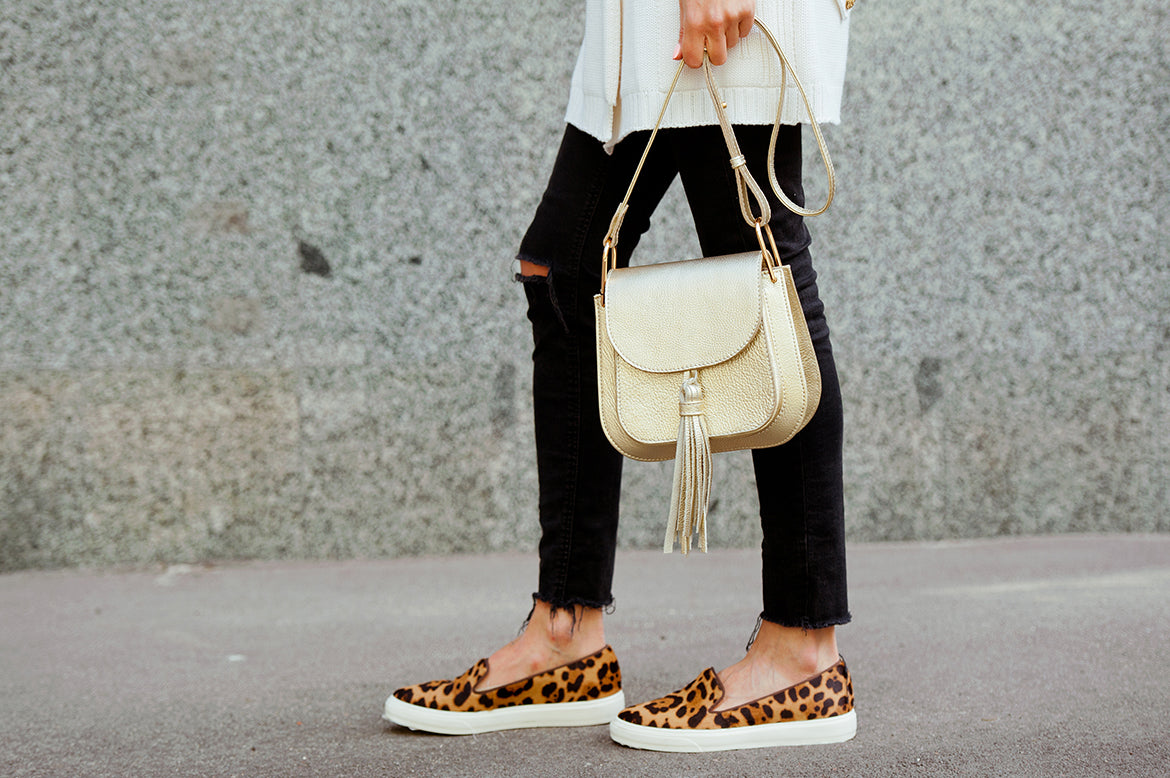 Model wearing leopard skin sneakers